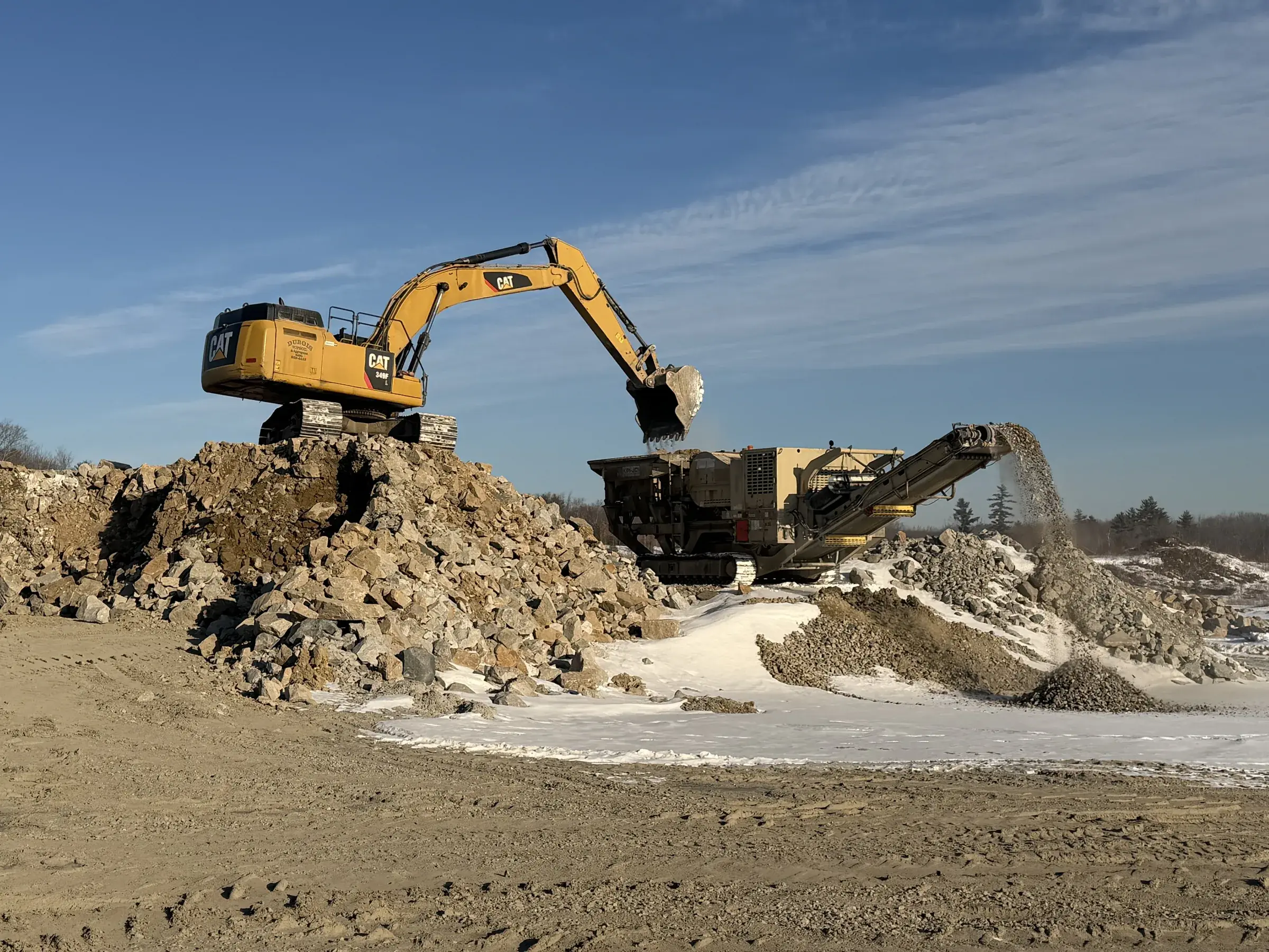 CAT wheel loader carrying a large stone block at the Dubois pit